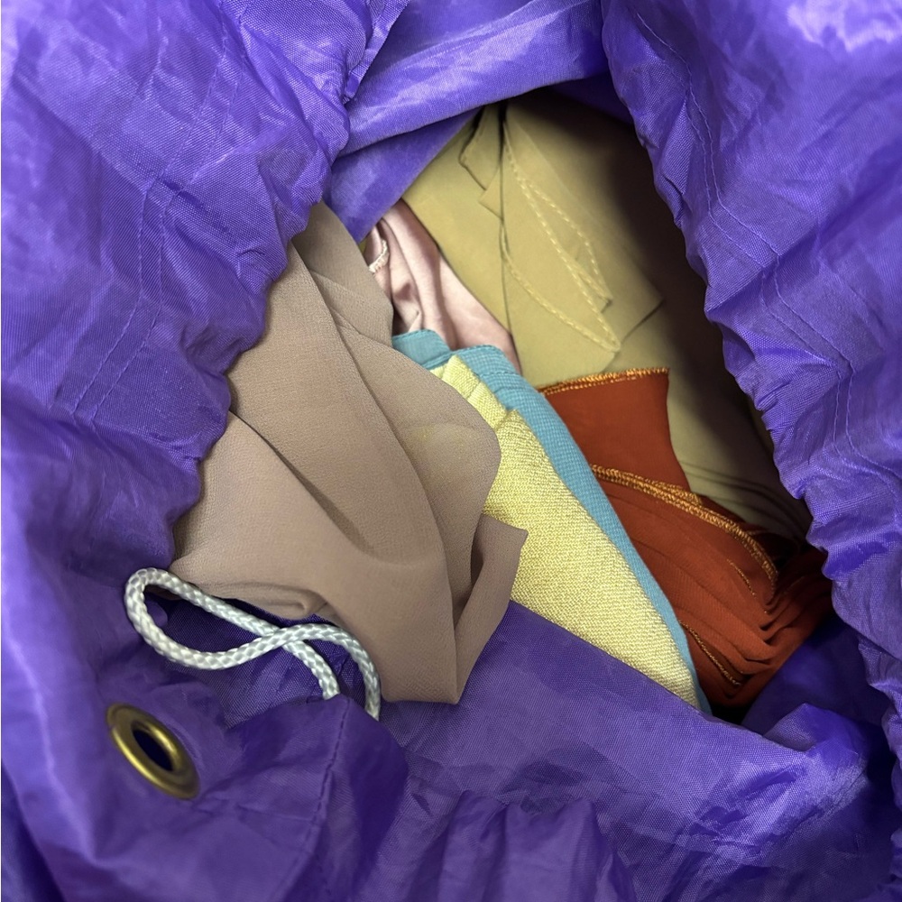 Purple Drawstring Bag with Multicolor Contents